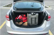  ?? DALE EDWARD JOHNSON ?? The Ford Fusion Energi SE plug-in hybrid offers little trunk space because of the battery. With three items, including two carry-on cases and one checked bag, the trunk is at full capacity.