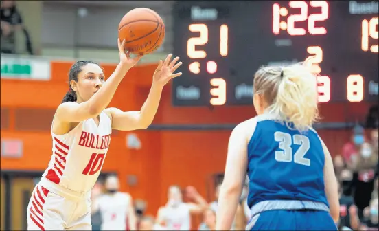  ?? PHOTOS BY KYLE TELECHAN / POST-TRIBUNE ?? Crown Point’s Alyvia Santiago (10) puts up a shot over the defense of Carroll’s Delane Sheets during the Class 4A LaPorte Semistate game on Saturday.