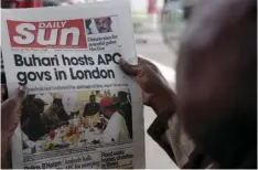  ?? PHOTO/SUNDAY ALAMBA ?? In this July 2017 file photo, a man reads a story about Nigeria’s President Muhammadu Buhari after the government released a photo of Buhari more than two months after he left for London for medical treatment, in Lagos, Nigeria. In Nigeria and other African countries, fighting fake news is vexing and divisive, especially as major elections loom. AP