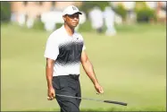  ?? Mike Lawrie / Getty Images ?? Tiger Woods reacts after putting on the 18th green during the third round of the Quicken Loans National on Saturday.