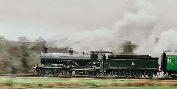  ??  ?? Above: LSWR T9 ‘Greyhound’ 4-4-0 No. 30120 lives up to its name as it romps away from Corfe Castle, during a 30742 Charter on the Swanage Railway on February 24. Part of the National Collection, its boiler certificat­e expires in September. GRAHAM NUTTALL