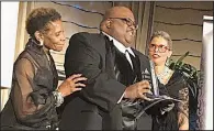  ??  ?? Honoree Eric W. Payne (center) with Rose Barnes, co-chairman of the Delta Presents Hall of Fame, and Jannie Cotton, co-chairman of the Delta Presents Outreach Foundation Inc. board of directors