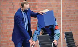  ?? Photograph: Tobias Schwarz/AFP/Getty Images ?? The defendant, right, arriving at court last October, has pleaded not guilty to the murders of 3,518 prisoners from 1942-1945.