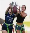  ?? Ashley Landis/Associated Press ?? Aly Young, 17, left, and Shale Harris, 15, reach to catch a pass as they try out for the Redondo Union High School girls flag football team in Redondo Beach, Calif.