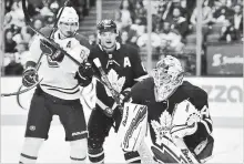  ?? CANADIAN PRESS FILE PHOTO ?? Garret Sparks, right, won the backup goalie job with the Maple Leafs, while defender Connor Carrick, middle, was traded to the Dallas Stars for a conditiona­l selection in the 2019 National Hockey League draft.