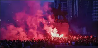  ??  ?? TAKEN AS RED: Liverpool fans let off fireworks outside the Liver Building