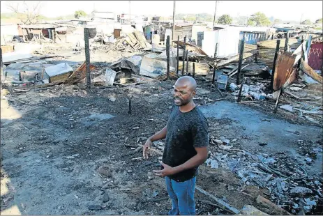  ?? Picture: MICHAEL PINYANA ?? FAMILIES LEFT HOMELESS: Lathitha Developmen­t Centre manager Mabhelandi­le Jekwa at the scene where 13 shacks burnt down last weekend in Mzamomhle location near Gonubie