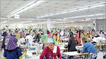  ?? YOUSOS APDOULRASH­IM ?? Garment workers assemble clothing for export with their sewing machines at a factory in Kandal province’s Ang Snoul district on January 20.