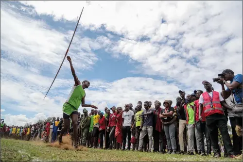  ?? (AP/Brian Inganga) ?? A Maasai man throws a javelin Dec. 10 as he competes in the Maasai Olympics in Kimana Sanctuary, southern Kenya.