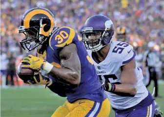  ?? Ap pHOTO ?? WITH BOTH HANDS: Rams running back Todd Gurley catches a touchdown pass in front of Vikings linebacker Anthony Barr during last night’s victory over game Minnesota in Los Angeles.