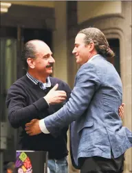  ??  ?? Federico Acosta, a Mexican who traces his lineage back 16 generation­s back to Moctezuma's daughter, left, embraces Italian Ascanio Pignatelli also of the 16th generation descended from Hernan Cortes' daughter, during a press conference in Mexico City on Friday.