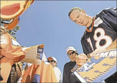  ?? Photo by AP ?? Attendance at Broncos summer practices averages nearly 3,000 per day as Manningman­ia easily replaces Tebowmania as source for Denver excitement.