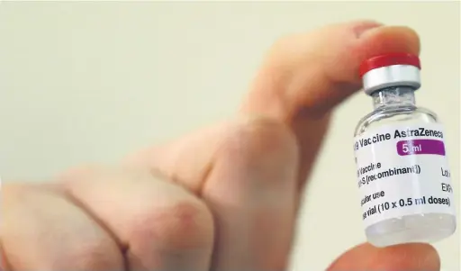 ?? Picture: Gareth Fuller ?? A vial of doses of the Oxford University/astrazenec­a Covid-19 vaccine is checked as the first batches arrive across the country.
