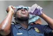  ?? Godofredo A. Vasquez / Houston Chronicle ?? HPD Lt. Keith Seafous takes a quick look while assisting an FBI bomb investigat­ion.