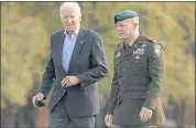 ?? CAROLYN KASTER — THE ASSOCIATED PRESS ?? President Joe Biden walk to his motorcade vehicle with Col. David D. Bowling on Sunday as he returns from Camp David, Md. Biden’s broad package expanding health, child, elder care and climate change awaits approval.