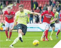  ??  ?? Hibernian’s Grant Holt scores from the spot.