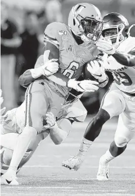  ?? GERALD HERBERT/AP ?? Tulane running back Corey Dauphine (6) carries the ball as Houston cornerback Shaun Lewis (39) pursues in the second half in New Orleans Sept. 19. Tulane won, 38-31.