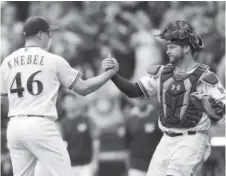  ?? Mike McGinnis, Getty Images ?? Corey Knebel celebrates with Stephen Vogt after the Milwaukee Brewers’ 4-3 victory over the Cincinnati Reds on Thursday.