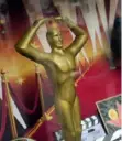  ?? Chris Pizzello/Invision/AP ?? A souvenir Oscar statue is pictured in the window of a Hollywood souvenir shop on Wednesday in Los Angeles.