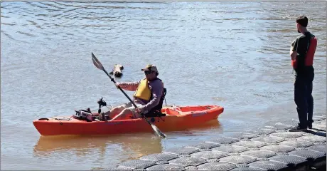  ??  ?? LEFT: Hugh Siniard of Cartersvil­le paddles a kayak back to the Oostanaula River bank under the watchful eye of Chris King. Kayaks were made available for testing by the Cedar Creek RV and Outdoor Center on Saturday during the annual Trout Unlimited...