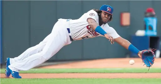  ?? NATHAN DENETTE/THE CANADIAN PRESS ?? Put to work right off the bat in his Bisons debut, third baseman Vladimir Guerrero Jr. goes flat out for a first-inning grounder. He also walked three straight times.
