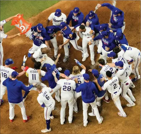  ?? GODOFREDO A. VÁSQUEZ — THE ASSOCIATED PRESS ?? Texas Rangers’ Adolis Garcia celebrates after hitting a game-winning home run against the Arizona Diamondbac­ks during the 11th inning in Game 1 of the baseball World Series Friday, Oct. 27, 2023, in Arlington, Texas. The Rangers won 6-5.