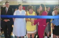  ?? KEVIN TUSTIN — DIGITAL FIRST MEDIA ?? Our Lady of Angels Principal Susan Lowe, center left, and Cardinal O’Hara Principal Eileen Vice, center right, cut the ribbon on their first year of a combined learning space together Wednesday morning. OLA students will attend classes at O’Hara after being displaced from their Ridley school by a July fire. At the same time, O’Hara is celebratin­g 55 years as an archdioces­an high school.