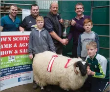  ??  ?? James Clifford Cahercivee­n with his Supreme Scotch Lamb champion at the Miltown Ram Lamb and Aged Ram Show and Sale at Miltown Mart last week. Pictured with James are Dan McCarthy (Secretary of Milltown Mart), Paudie O’Sullivan (Milltown Mart...