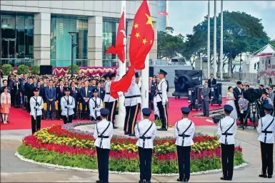  ?? ZHANG WEI / CHINA NEWS SERVICE ?? A flag-raising ceremony on Sunday at Golden Bauhinia Square in Hong Kong marks the 21st anniversar­y of the city’s return to the