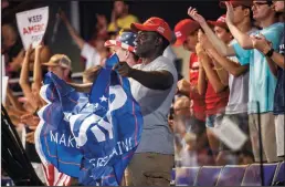  ?? TRAVIS LONG/THE NEWS & OBSERVER ?? People cheer during a campaign rally for President Donald Trump on Wednesday at East Carolina University in Greenville, NC.