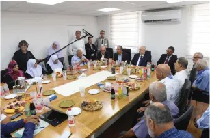  ?? (Mark Neyman/GPO) ?? PRESIDENT REUVEN Rivlin, with Kafr Kassem Mayor Adel Badir (to his right), sits yesterday at the head of the table with representa­tives of the local women’s council.