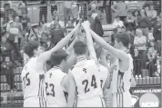  ?? Photo by Becky Polaski ?? Members of the Crusader basketball team celebrate with the D9 1A boys’ championsh­ip plaque after defeating Union 50-35 in Saturday’s title game.