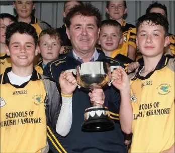  ??  ?? Jim Dempsey presents the cup to Kilrush joint captains Charlie O’Sullivan and Pa Mahon.