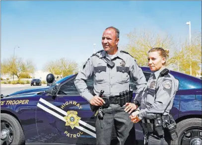  ?? Rachel Aston ?? Las Vegas Review-journal @rookie__rae Nevada Highway Patrol troopers Joseph Dellabella and his wife, Trisa Dellabella, talk to reporters Tuesday in Las Vegas. They helped evacuate residents at a burning apartment complex on Saturday.