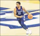  ?? John Peterson / Associated Press ?? UConn’s Brendan Adams (10) brings the ball down the court against Creighton on Saturday in Ohama, Neb.