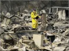  ?? ERIC RISBERG - THE ASSOCIATED PRESS ?? A Cal Fire official looks out at the remains of the Journey’s End mobile home park Wednesday, in Santa Rosa, Calif. Blazes burning in Northern California have become some of the deadliest in state history.