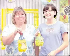  ?? PHOTO SUBMITTED ?? LeaAnn Bunting and her daughter, Sophie Jaquez, show off the bird feeders they created during a recent class hosted by the McDonald County Library.