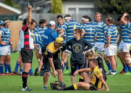  ?? PHOTOS: ALDEN WILLIAMS/STUFF ?? A referee issues a blue card - indicating a mandatory concussion test - during a club match in Canterbury last season.