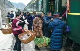  ?? ?? From left: A county fair is set up on a green train traveling between Guiyang and Yuping Dong autonomous county in Tongren, Guizhou province, where villagers sell freshly picked vegetables and local specialtie­s to passengers when the train pulls into one of the stations along the 337-kilometer route. Surrounded by festive decoration­s, passengers enjoy their ride. Vendors wait for the train’s arrival at a station along the route. Miao and Dong ethnic actors get ready to perform in the onboard gala to celebrate the upcoming Spring Festival.