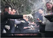  ?? PHOTO: GETTY IMAGES ?? Helping out . . . Prime Minister Jacinda Ardern and Finance Minister Grant Robertson help serve breakfast to the crowds after the dawn service at the Waitangi Treaty Grounds on Saturday.