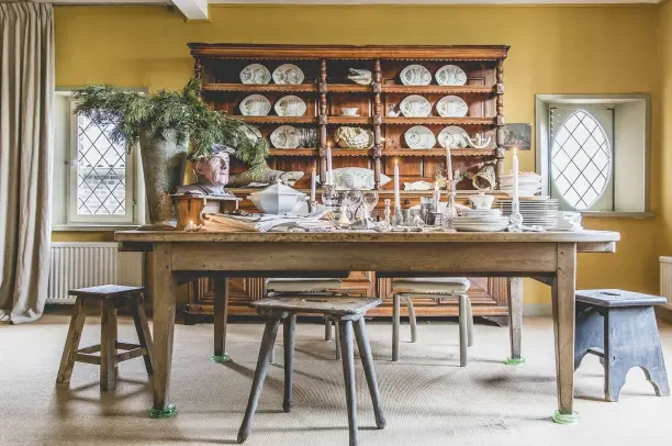  ??  ?? ABOVE The dining room is now in what was once the wedding chamber of the former council house. The yellow walls are Farrow & Ball ‘India Yellow’. The table is 18thcentur­y French, while the dresser is from the late 1800s and holds Marly’s collection of...