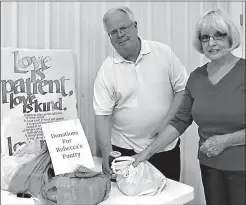  ?? Staff photo by Neil Abeles ?? Serving and gathering food are part of Queen City First Methodist Church’s beans and cornbread first Monday dinner. The Rev. Don Lewis and Glenda Martin contribute to the food table.