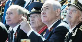  ?? MAXIM SHIPENKOV / POOL PHOTO VIA THE ASSOCIATED PRESS ?? Russian President Vladimir Putin, left, and Israeli Prime Minister Benjamin Netanyahu, second right, watch a military parade in Moscow on Wednesday celebratin­g 73 years since the WWII victory.