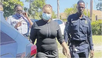  ?? (Photo: Akera Davis) ?? National Commercial Bank employee Khadene Thomas (centre) is hauled before the courts recently to answer fraud charges.