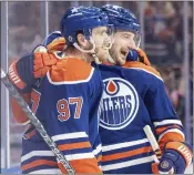  ?? JASON FRANSON — THE CANADIAN PRESS VIA AP ?? Edmonton's Connor McDavid, left, celebrates his 100th assist this season with Zach Hyman, who scored the goal.