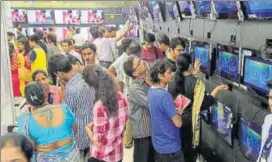  ?? AP ?? People crowd an electronic­s shop, a day ahead of the implementa­tion of the nationwide Goods and Services Tax (GST) in Mumbai on Friday.