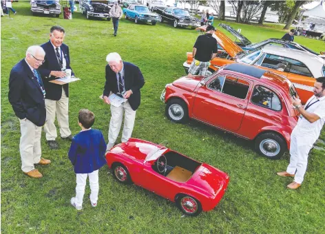  ?? PHOTOS: CAM HUTCHINS ?? Young Massimo explains the virtues of his all-electric 1957 SILA Bimboracer to the Crescent Beach Concours judges. At left, a 1930 Packard 733 Dual Cowl Sport Phaeton rolls into the show.