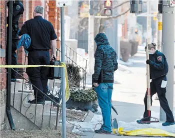  ?? JOHN RENNISON THE HAMILTON SPECTATOR ?? Police carry shovels, rakes and other excavating equipment into 104 Wellington St. N. Police recovered the body of an infant there Thursday afternoon after securing a search warrant the day before.