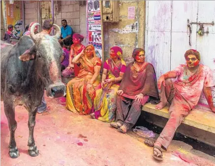  ?? Francois Xavier Marit AFP / Getty Images ?? REVELERS in Jaisalmer, India, relax after letting loose at last year’s Holi, a Hindu celebratio­n also known as the Festival of Colors.