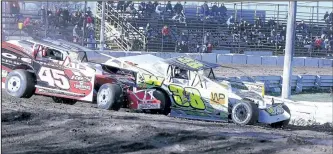  ??  ?? Race cars in the modifi ed 358 class get used to the resurfaced track at Merrittvil­le Speedway.